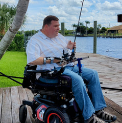 Hands-on Adjustable, Hinged Fish Fighting Rod Holder for Wheelchair Seat - Mark in wheelchair on dock closeup